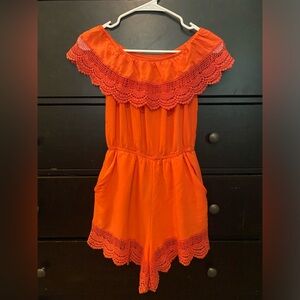 An orange romper, size small, brand m i a m a.